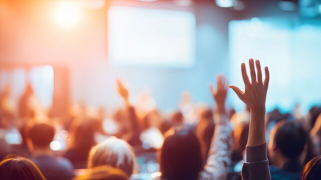 Professional conference audience raising hands  to ask questions during business presentation,hands of people raised at a concert 