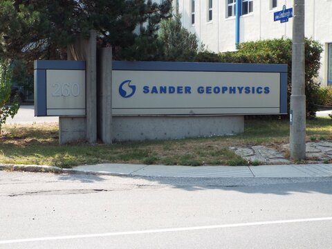Ottawa, Ontario, Canada-July 15, 2025: A roadside monument sign for "Sander Geophysics" stands at the entrance to 260 Hunt Club Road.