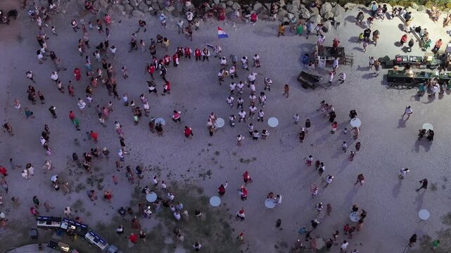 Drone footage of pirate themed performance in Omis with crowd and dramatic night atmosphere in historic square.