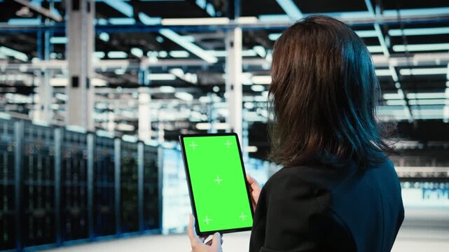 Green screen tablet, optimizing servers and admin in data center doing load balancing. Adjusting system parameters, mockup device and IT specialist in server farm improving efficiency, camera A