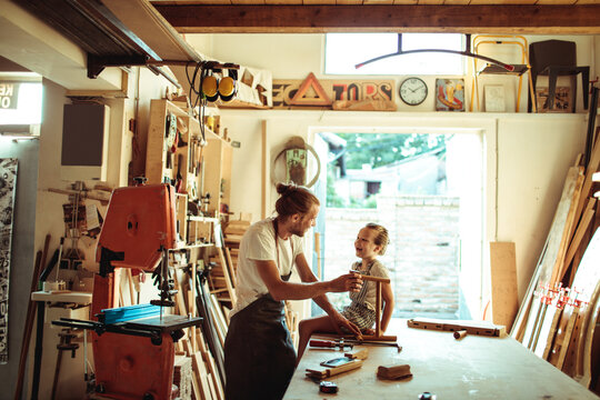 Man and child woodworking in home workshop