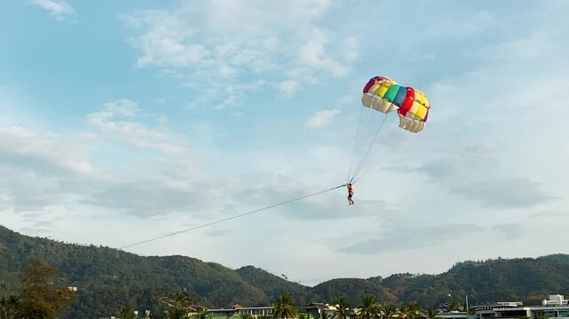 Parasailing over the ocean, slow motion view