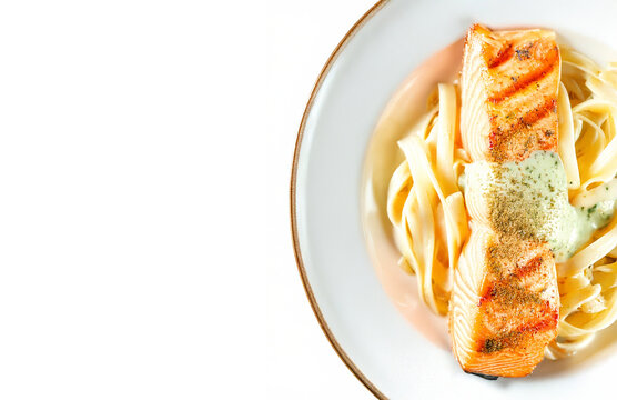 Grilled Salmon with Pasta on White Plate Isolated with Copy Space