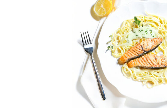 Grilled Salmon with Pasta on White Plate Isolated with Copy Space