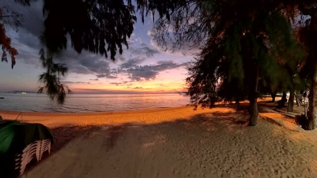 PATTAYA, THAILAND - NOVEMBER 2025 : View of Jomtien beach and beautiful sunset sky. Travel and tourism concept video.