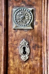 Handcrafted Antique Door Handle and Lock Detail on a Weathered Wooden Door