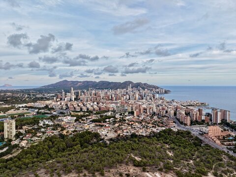 hilltop shot of vibrant coastal metropolis, expansive aerial image capturing shoreline and urban sprawl