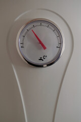 Water heater thermometer with red arrow and scale