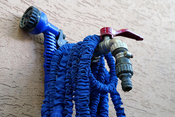 Outdoor tap for watering a garden plot. Water tap outside the building