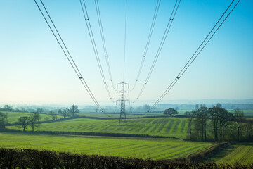 Sun setting behind the electric power lines running from Dungeness power station on the Kent coast south east England UK © Jevanto Protography