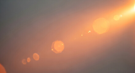 Radiant Orange Lens Flare and Bokeh on a Warm Gradient Background