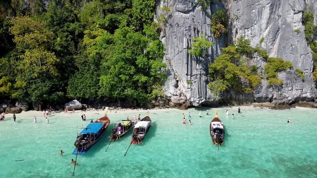PHI PHI DON, THAILAND - DECEMBER 24, 2019: Aerial view of long tail boats and tourists visting Monkey Beach