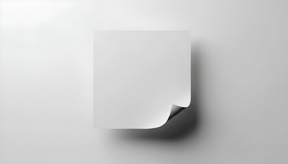 Blank white paper with curled corner on gray background