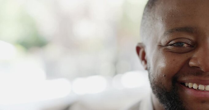Tight crop adult African man smiling, showing facial shifts in lit room, beard, copy space