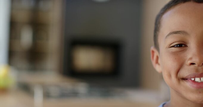 African American preteen seeing camera smiling laughing leaning over counter in kitchen, copy space