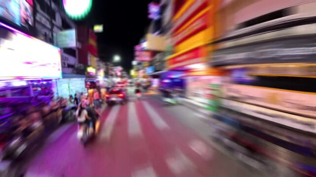 PATTAYA, THAILAND - NOV 2025 : Blurred view of Soi Buakhao street. Famous for beer bars, massages, hotel and various kind of nightlife places. Travel and tourism concept time lapse shot.