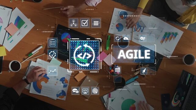 A top-down view of a diverse group engaged in agile project management, utilizing charts, laptops, and visual aids to enhance teamwork and productivity. Raster