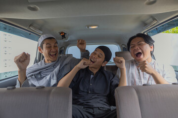 Excited Muslim Men Singing And Dancing Like Karaoke In Back Seat Of Car During Holiday Trip
