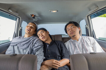 Tired Muslim Friends Sleeping Together In Back Seat Of Car During Long Holiday Road Trip