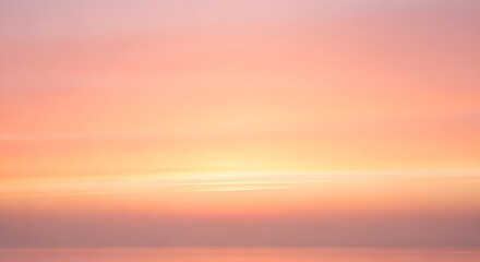 A serene sunset paints the sky in soft hues of pink and orange, reflecting gently on the tranquil ocean.