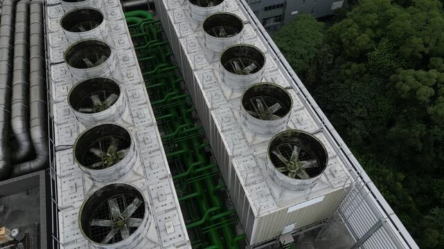 Aerial top view of industrial cooling towers for AI data center server farm.