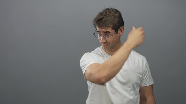 Man runs hand through hair and touches forehead while adjusting glasses in a studio six frame sequence showing repeated gestures; embarrassment reflection.