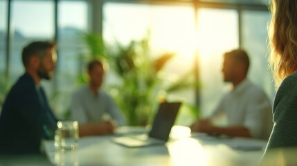 Fototapeta premium Business people brainstorming and communicating at a modern office during golden hour, representing teamwork and success