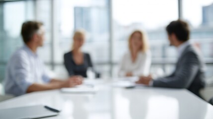 Business team collaborating around a table in a blurred modern office setting, discussing ideas and plans