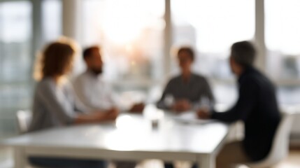 Business people meeting in a modern office, collaborating on a project, blurred background for concept of teamwork and discussion