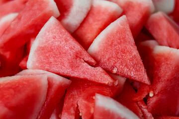 Close up of fresh ripe red watermelon slices piled together, showing juicy texture and vibrant color, perfect for a healthy summer food background.
​Keywords (49)