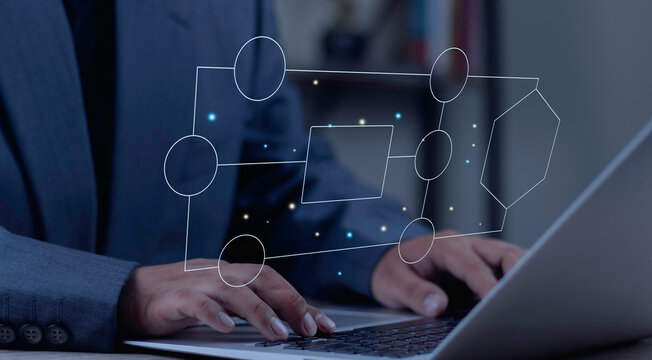 Businessman typing on laptop with virtual flowchart diagram. Concept of workflow automation, algorithm design, and business process strategy.Workflow Business Solution Outline