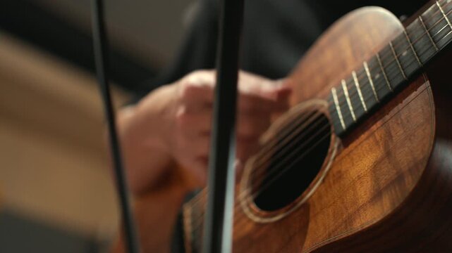 Close up musician man playing guitar and performing live professional in recording studio, practicing rehearsal with instruments, music production creative and energetic live performance.
