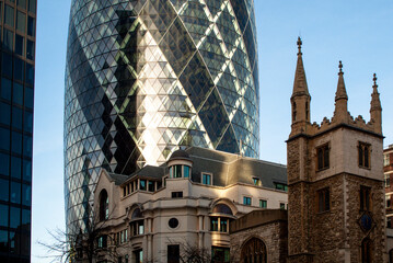 Gherkin skyscraper towering london historical architecture and church
