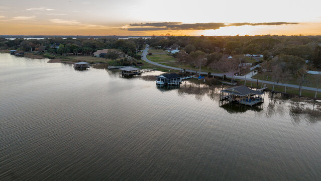sunset over the lake with boat houses on the shoreline