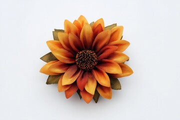 A vibrant, multi-layered artificial flower with warm orange and brown petals