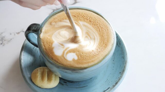 Latte art ritual close up of creamy coffee with detailed foam pattern Latte culture celebrates barista skill latte texture highlights craftsmanship latte moment inspires modern cafe lifestyle
