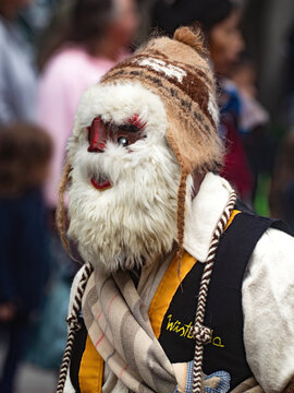 Dancer from the Huaconada, a ritual dance performed in Mito, Junin, Peru. The Huaconada takes place during the first days of January. The dancer is wearing a carved mask designed to inspire respect.