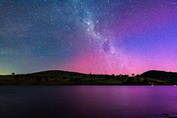 A Pink Aurora Australis and the Milky Way Shimmers Over the Dam