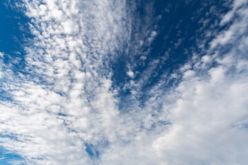 Cumulus and cirrus clouds in the blue sky