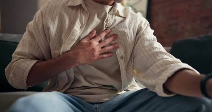 Hands, person and discomfort of chest pain at house for heart attack, lung infection and pressure. Chronic, risk and cardiac emergency of respiratory distress, rapid heartbeat and shortness of breath