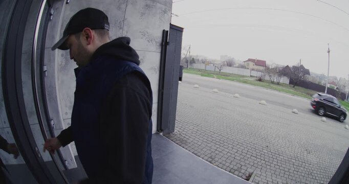 Man Wearing Casual Clothes Arrives at Front Porch, Removes Keys, Unlocks Entrance Door, Opens Door, and Walks Inside House, Recorded by Wide Angle Smart Doorbell Camera Monitoring Private Property.