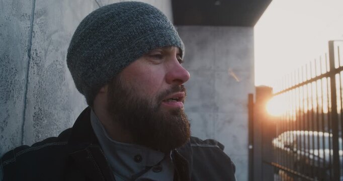 After Heavy Snow Shoveling, Worker Pauses to Recover, Lifting Face Toward Fading Sunlight. Concept of Quiet Moment of Fatigue and Relief, Human Emotion Behind Demanding Winter Maintenance Work.