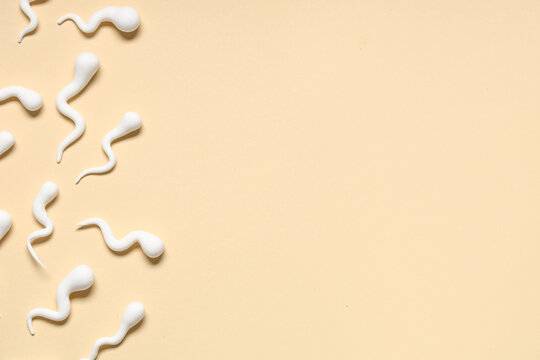 Sperm cells on beige background