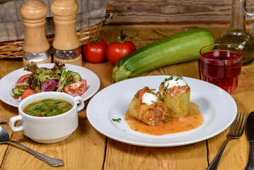 Hearty Home-Cooked Meal with Stuffed Zucchini, Soup, and Fresh Salad