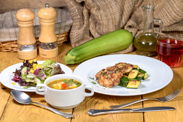 Healthy and Delicious Home-Cooked Meal with Chicken, Zucchini, Soup, and Salad