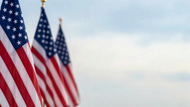Three American Flags Waving in the Wind with a Copyspace Background.