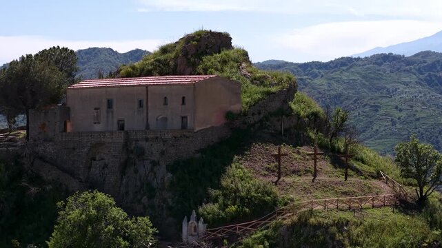 Aerial Tilt Up Revealing Pentefur Castle in Green Mountains Savoca Sicily Italy