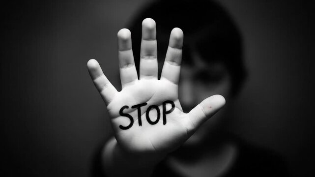 Man holding hand with stop sign written on palm, concept of prohibition and warning