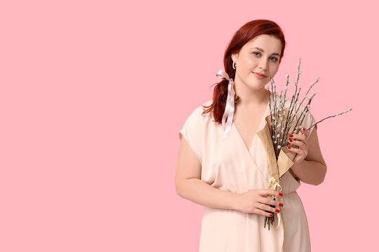 Beautiful young woman with pussy willow branches on pink background. Easter celebration