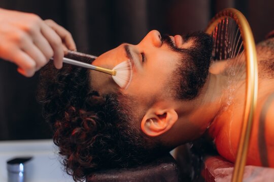 Man receiving professional facial spa treatment